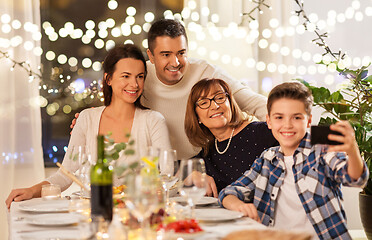 Image showing family having dinner party and taking selfie