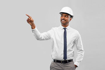 Image showing indian male architect in helmet showing something