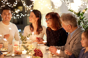 Image showing family with sparklers having tea party at home