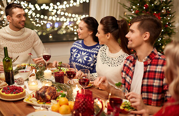 Image showing happy friends having christmas dinner at home