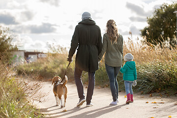 Image showing happy family walking with dog in autumn