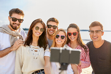 Image showing happy friends taking selfie on summer beach