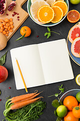 Image showing close up of notebook, fruits and vegetables