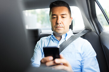 Image showing passenger or businessman using smartphone in car