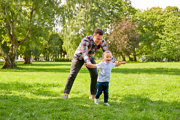 Image showing happy father with son playing in summer park