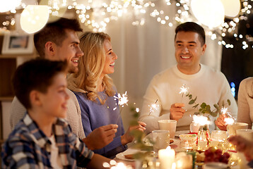 Image showing family with sparklers having tea party at home