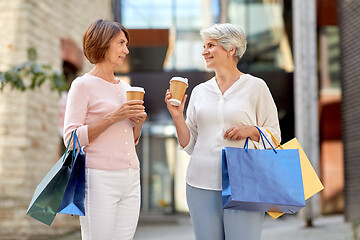 Image showing senior women with shopping bags and coffee in city