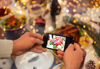 Image showing hands photographing food at christmas dinner