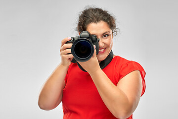 Image showing happy woman photographer with digital camera