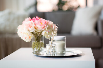 Image showing aroma reed diffuser, candle and flowers on table