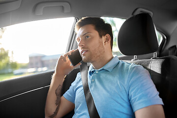 Image showing male passenger calling on smartphone in taxi car