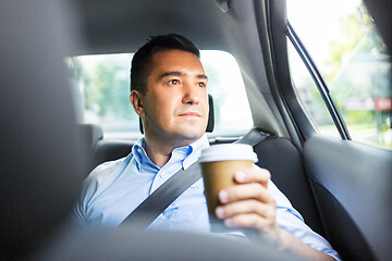 Image showing businessman with takeaway coffee on car back seat