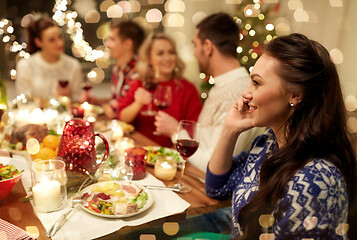 Image showing woman calling on smartphone at christmas dinner