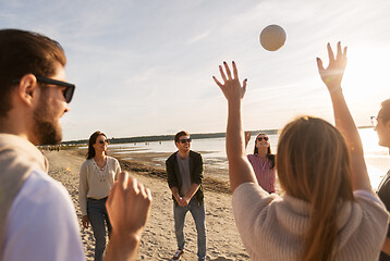 Image showing friends playing volleyball on beach in summer