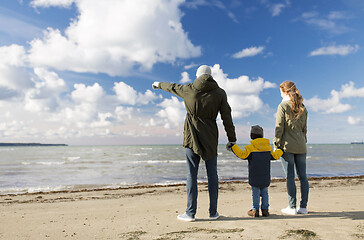 Image showing happy family at autumn beach looking at sea