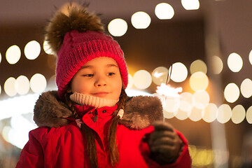 Image showing happy girl with sparkler at christmas market