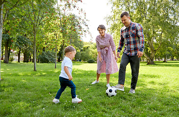 Image showing happy family playing soccer at summer park