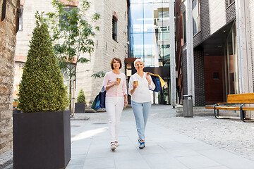 Image showing senior women with shopping bags and coffee in city