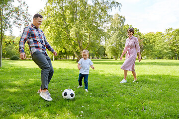 Image showing happy family playing soccer at summer park