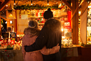 Image showing happy senior couple hugging at christmas market