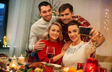 Image showing friends taking selfie at christmas dinner