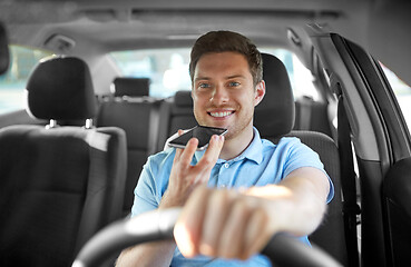 Image showing man driving car and recording voice by smartphone