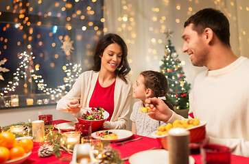 Image showing happy family having christmas dinner at home