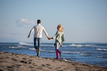 Image showing Loving young couple on a beach at autumn sunny day