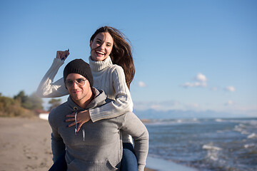 Image showing couple having fun at beach during autumn