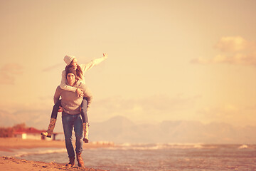 Image showing couple having fun at beach during autumn