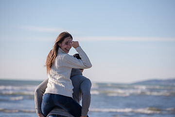 Image showing couple having fun at beach during autumn