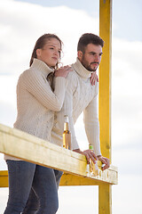 Image showing young couple drinking beer together at the beach