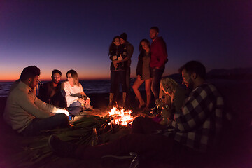 Image showing Friends having fun at beach on autumn day