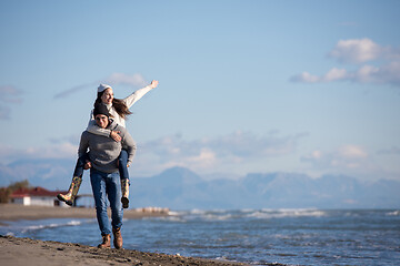 Image showing couple having fun at beach during autumn