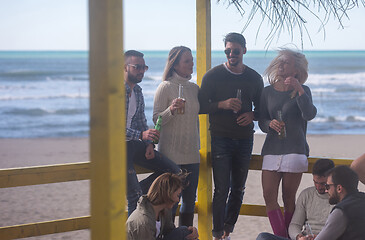 Image showing Group of friends having fun on autumn day at beach