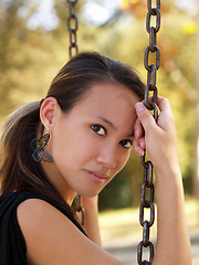 Image showing Young asian american woman on swing chains