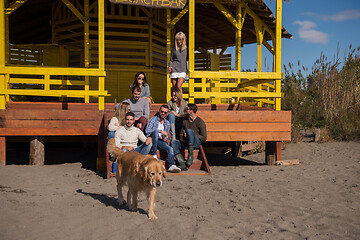 Image showing Group of friends having fun on autumn day at beach