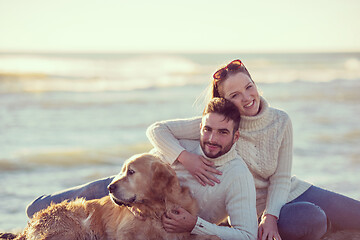 Image showing Couple with dog enjoying time on beach