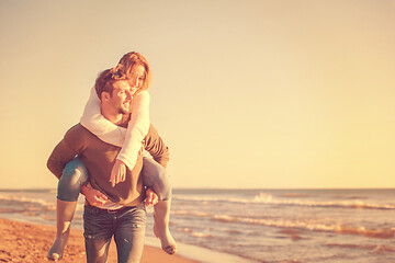 Image showing couple having fun at beach during autumn