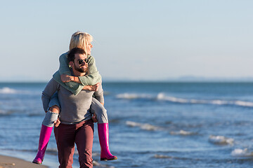 Image showing couple having fun at beach during autumn