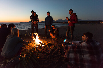 Image showing Friends having fun at beach on autumn day