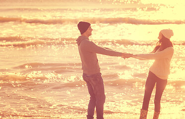 Image showing Loving young couple on a beach at autumn sunny day