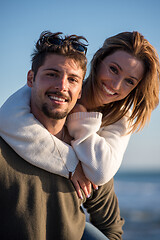 Image showing couple having fun at beach during autumn