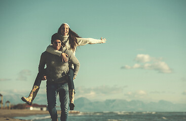 Image showing couple having fun at beach during autumn