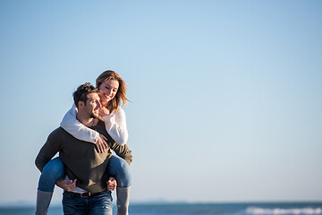 Image showing couple having fun at beach during autumn