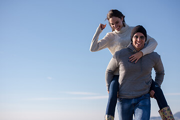 Image showing couple having fun at beach during autumn