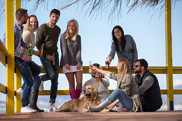 Image showing Group of friends having fun on autumn day at beach