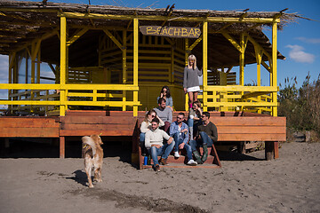 Image showing Group of friends having fun on autumn day at beach