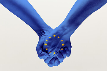 Image showing Male hands holding colored in EU flag
