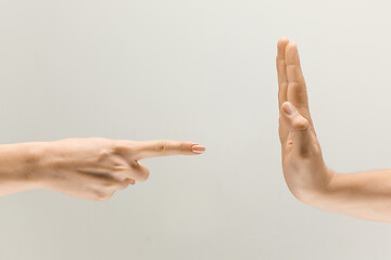 Image showing Male and female hands isolated on grey studio background